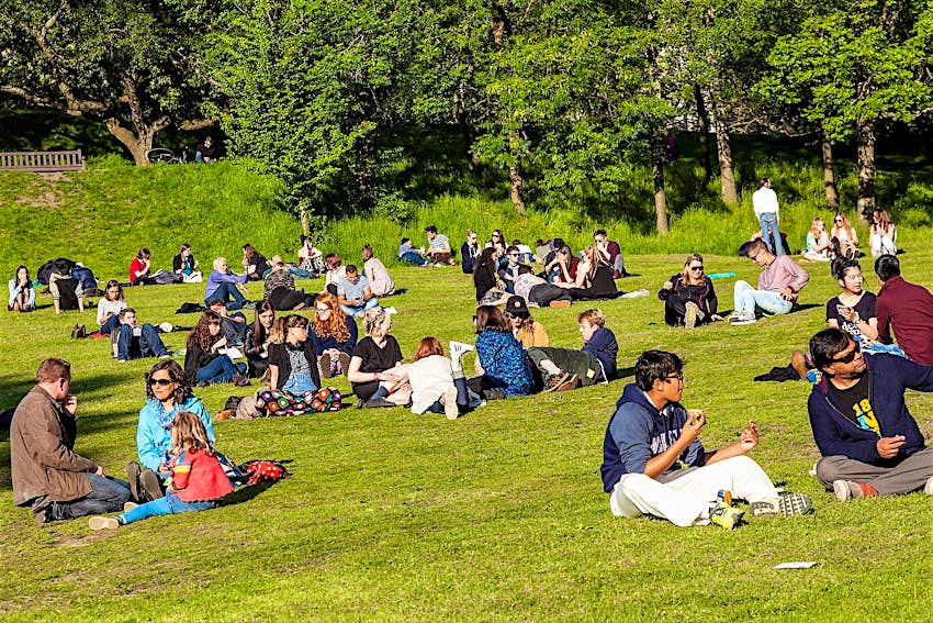 People sitting on the grass in Glasgow's Kelvingrove Park