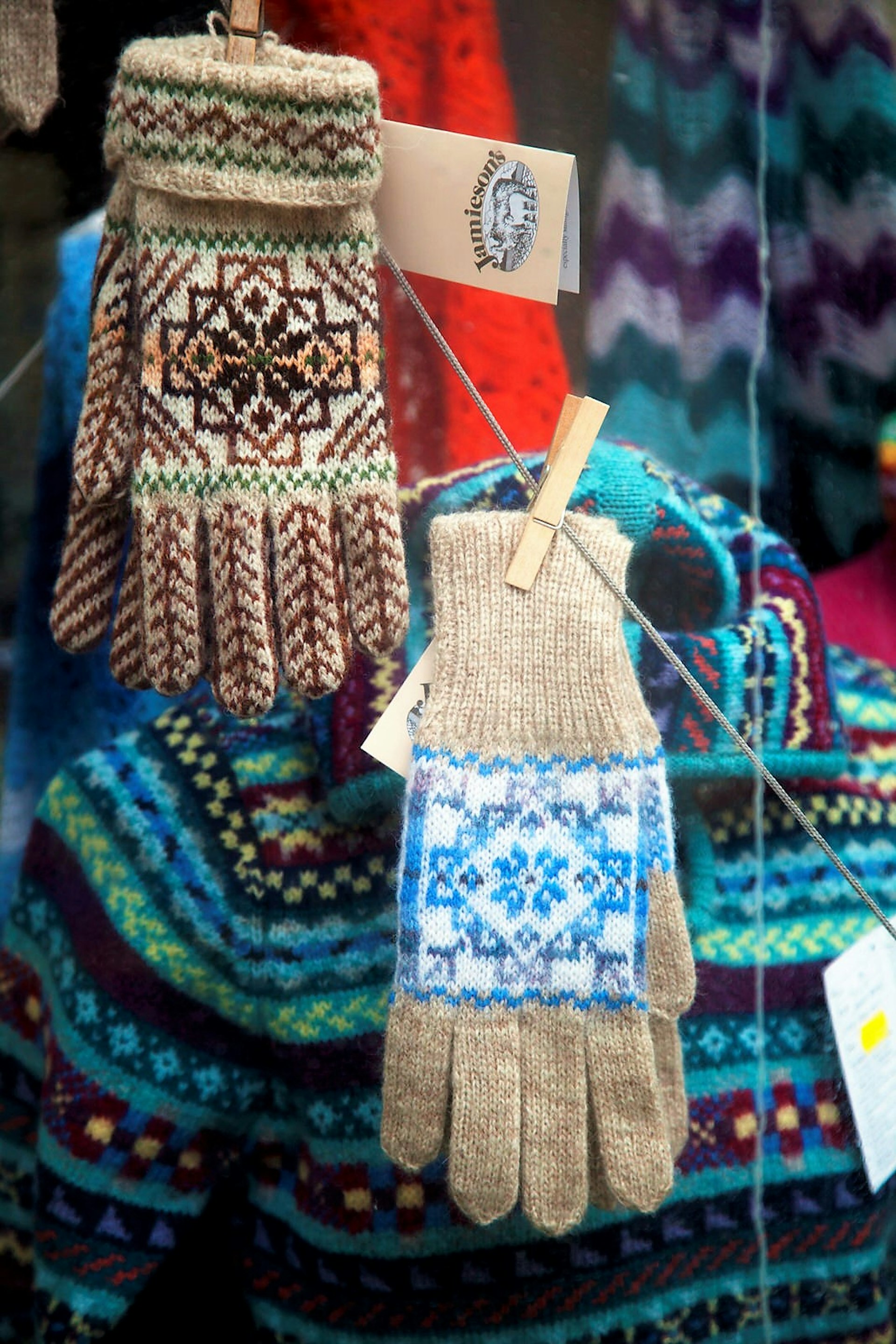 Some knitted gloves and other woollens in traditional Shetland designs