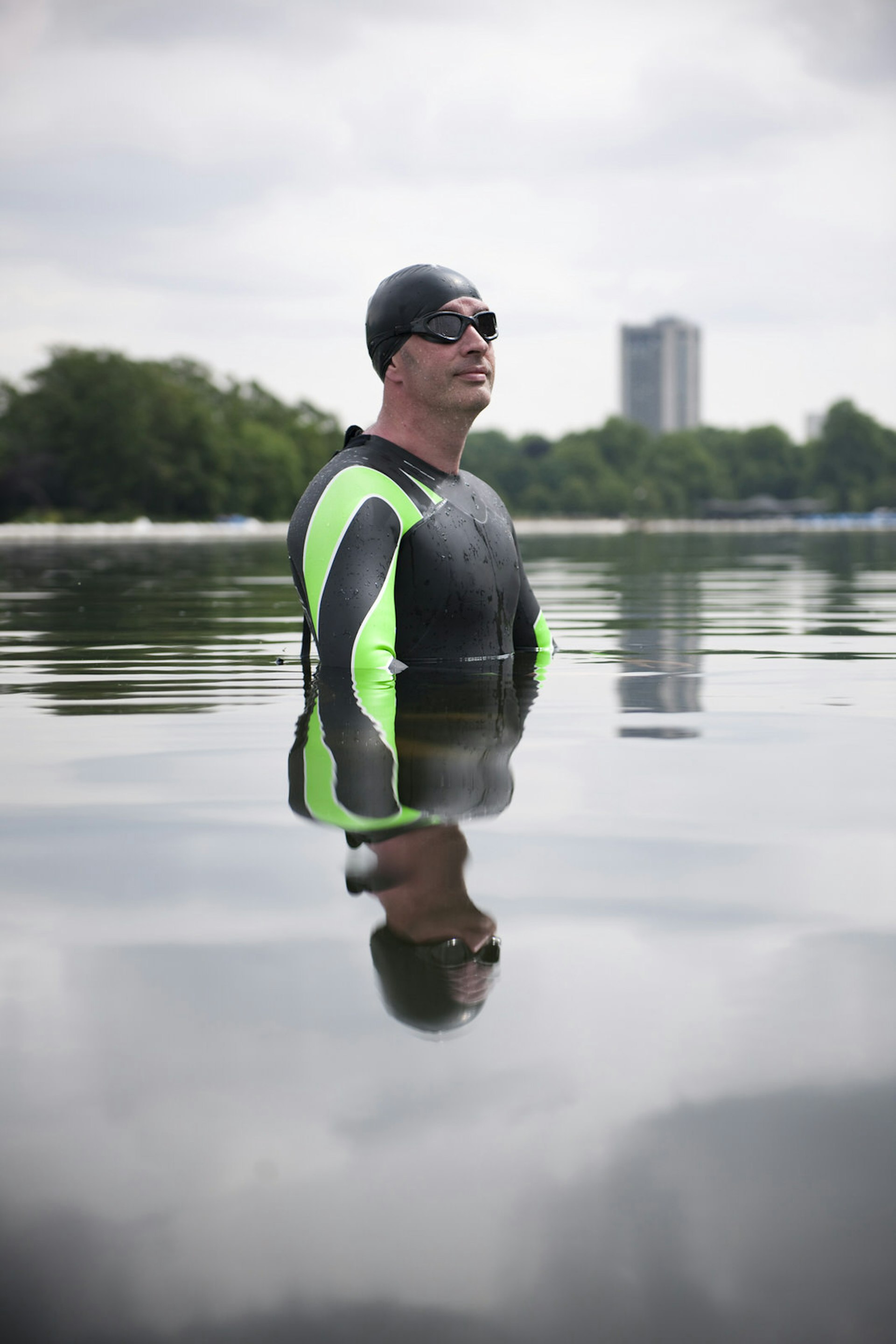 Man in wetsuit standing in The Serpentine, London