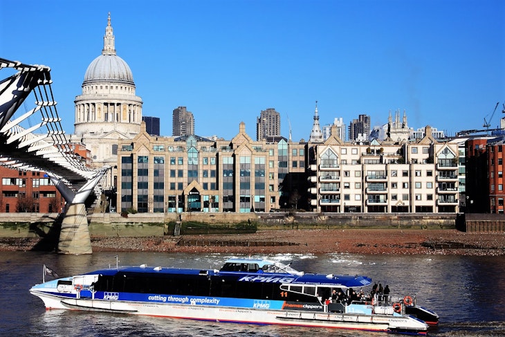 A Thames Clipper boats glides past St Paul's Cathedral on the river