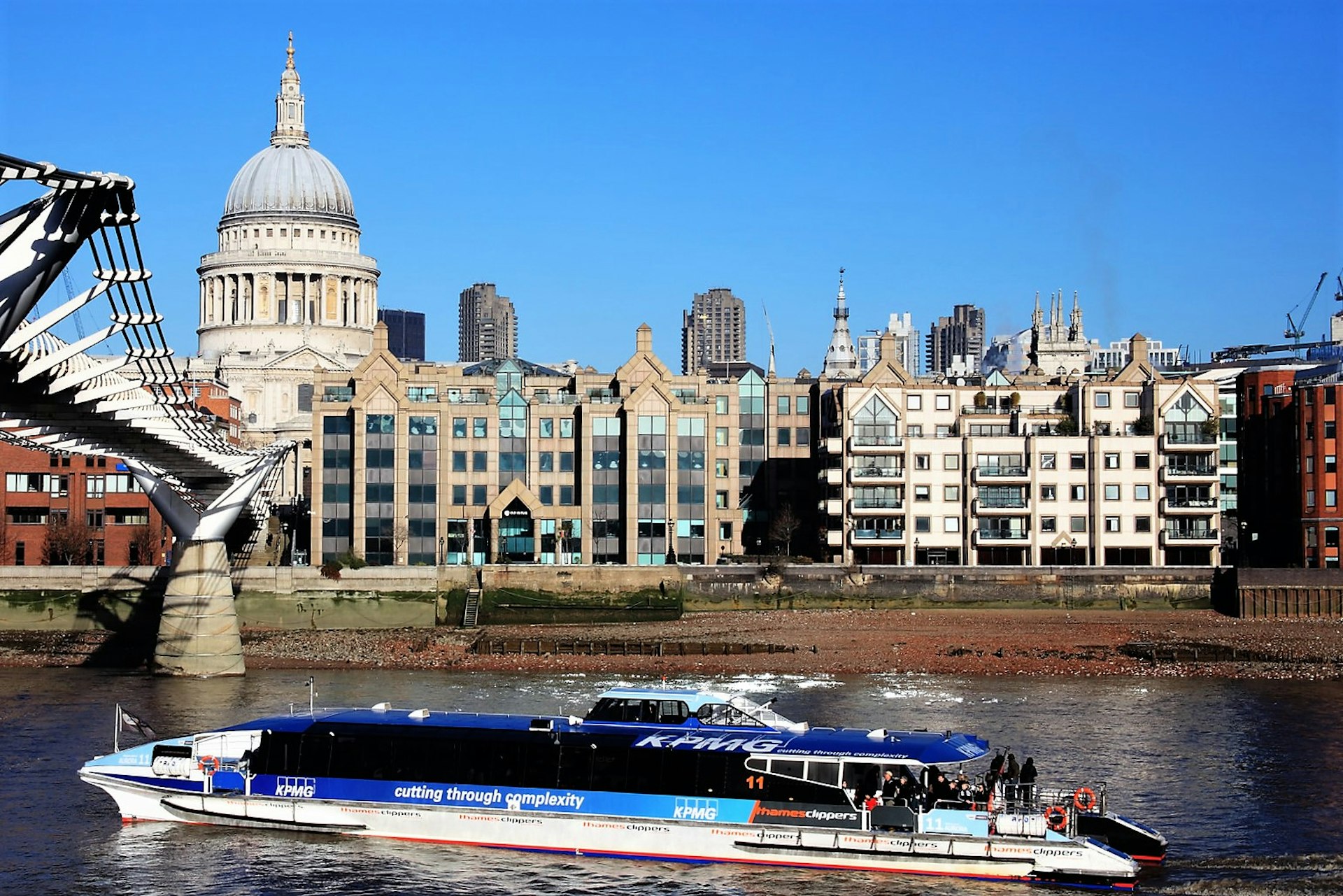 A Thames Clipper boat glides past St Paul's Cathedral on the river