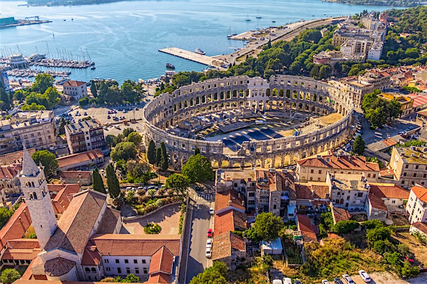 An aerial view of Pula's remarkably intact Roman Amphitheatre, beside the sea