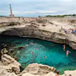 People jumping into the Grotta della Poesia