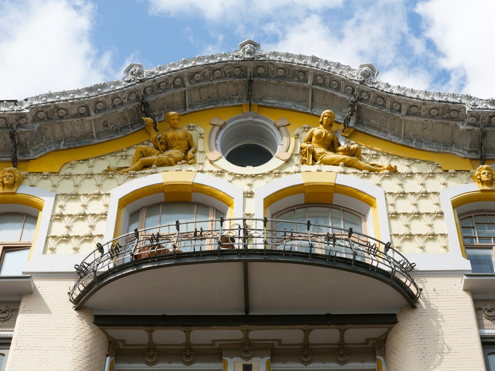 Elaborate facade with statues and balcony on a mansion in Moscow