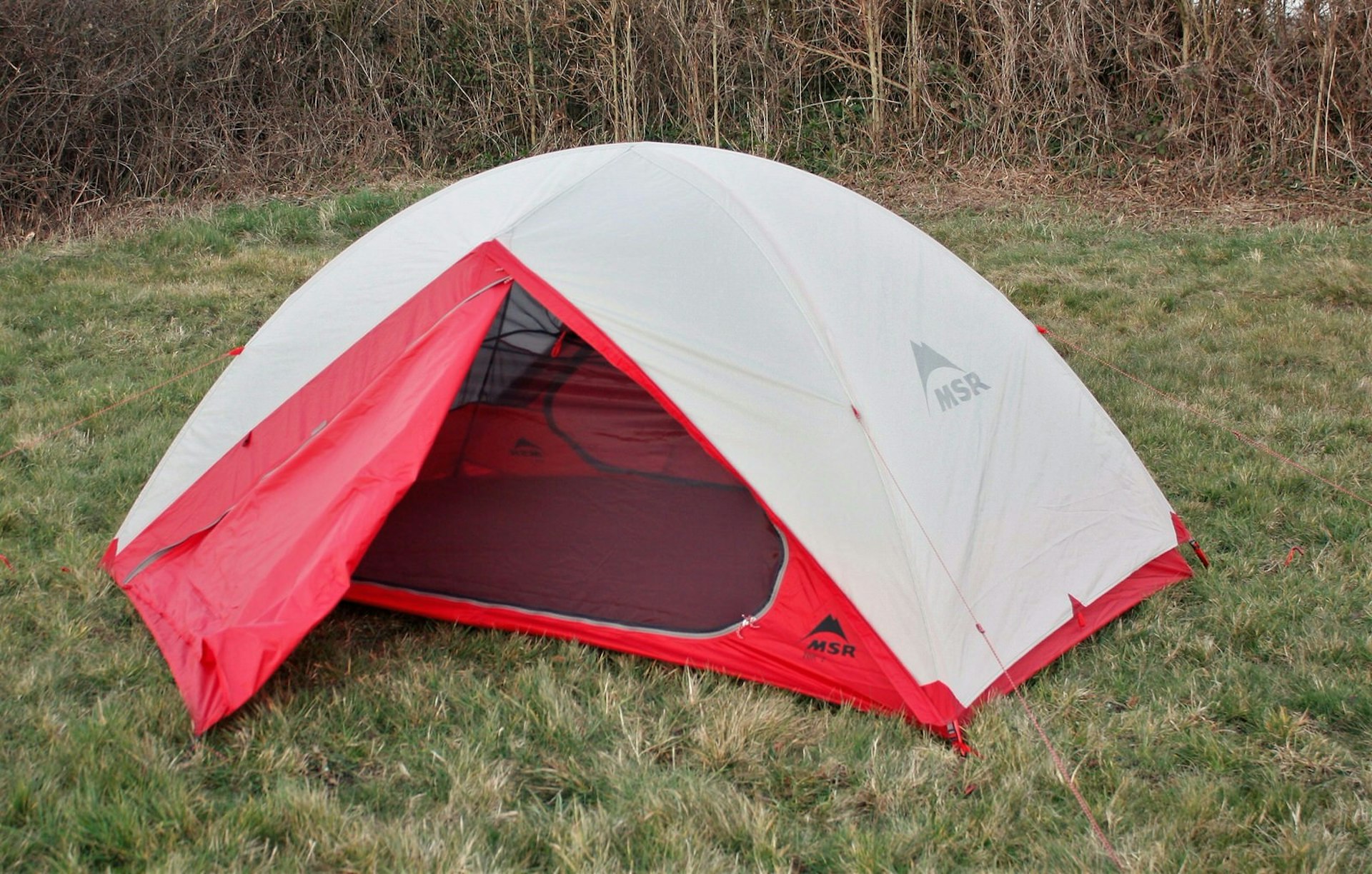 MSR’s Zoic 2 tent in red, pitched in a field 