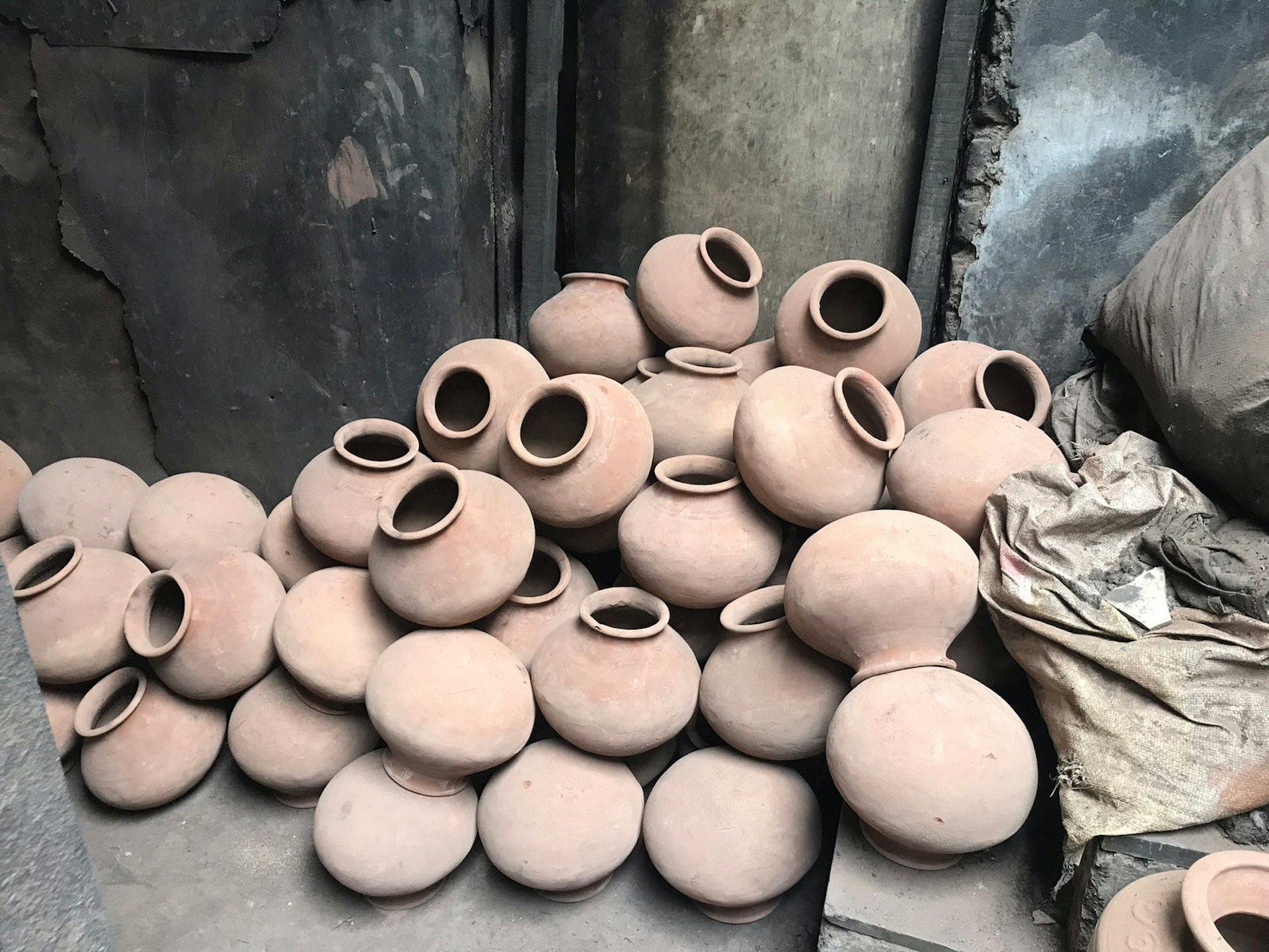 Clay pots piled outside a pottery workshop