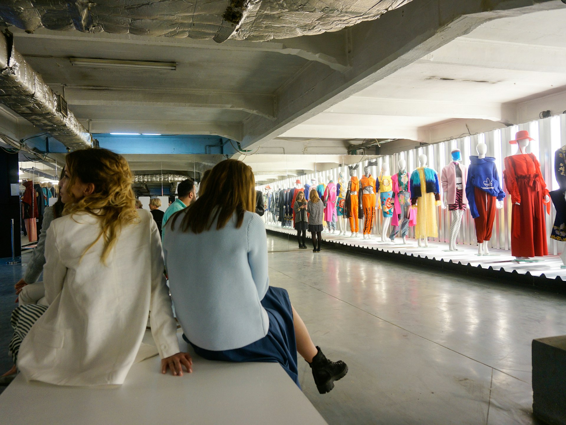 Colourful clothes on mannequins lined up at a fashion exhibition in Bucharest
