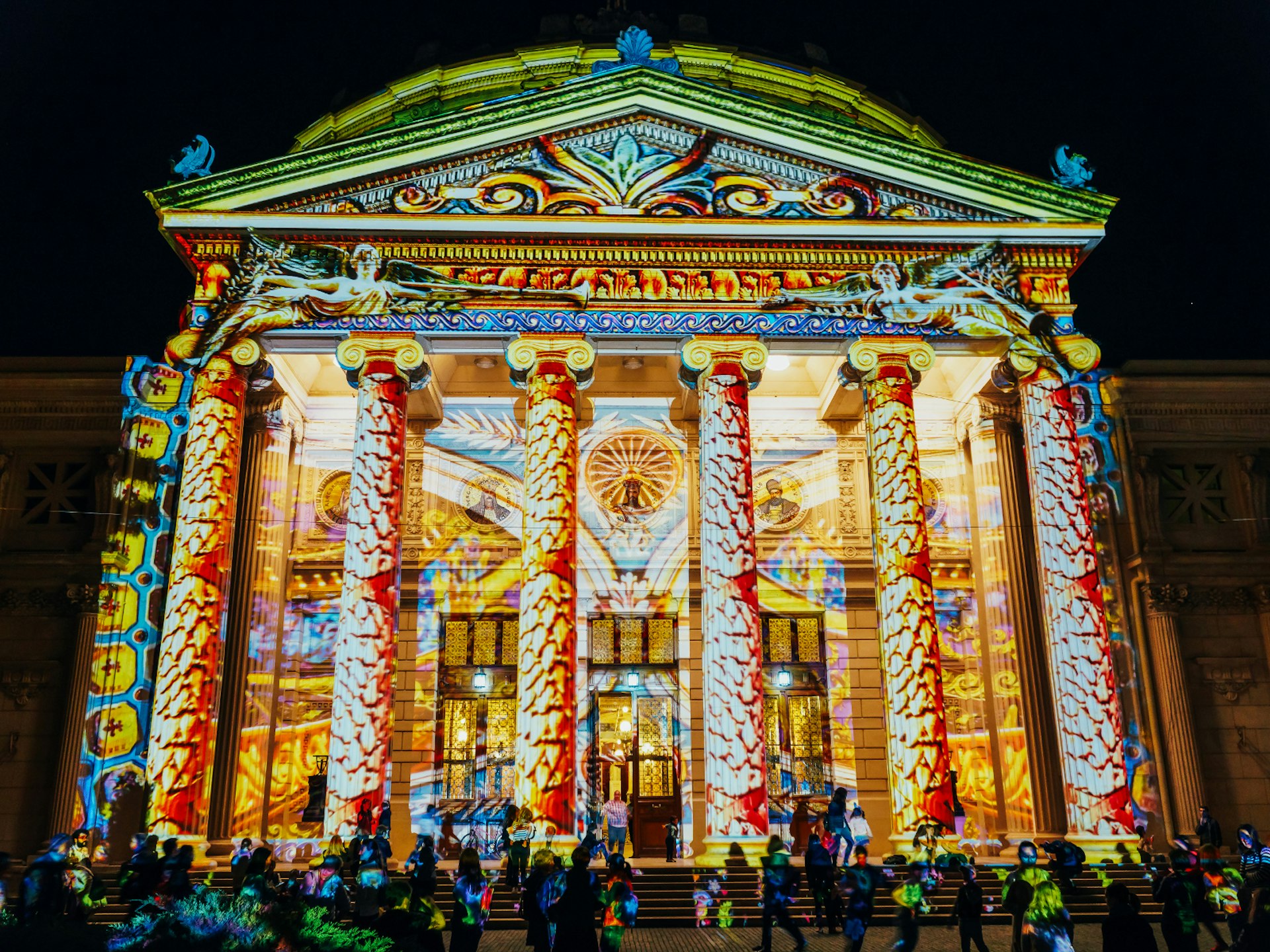 Colourful video projection on the facade of Bucharest's Romanian Athenaeum at night