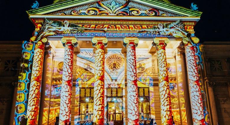 Romanian Athenaeum beautifully lit up at night during the Spotlight Bucharest International Light Festival © Radu Bercan / Shutterstock