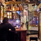 A man enjoys a drink at the bar of the Wee Pub