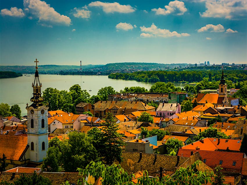 Red rooftops and church towers amid the greenery by the Danube in Belgrade's Zemun neighbourhood