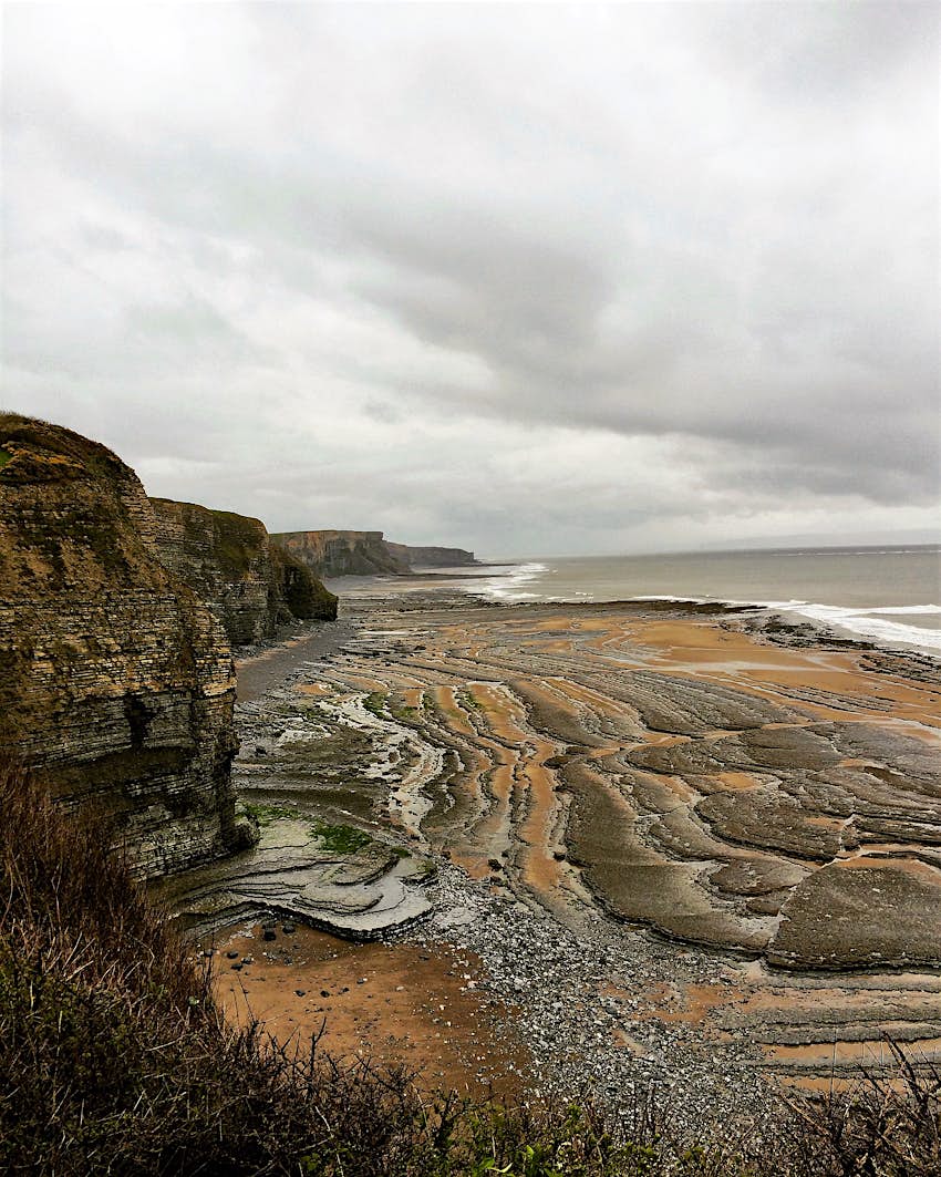 Grey clouds over Monknash beach which is famous for fossils