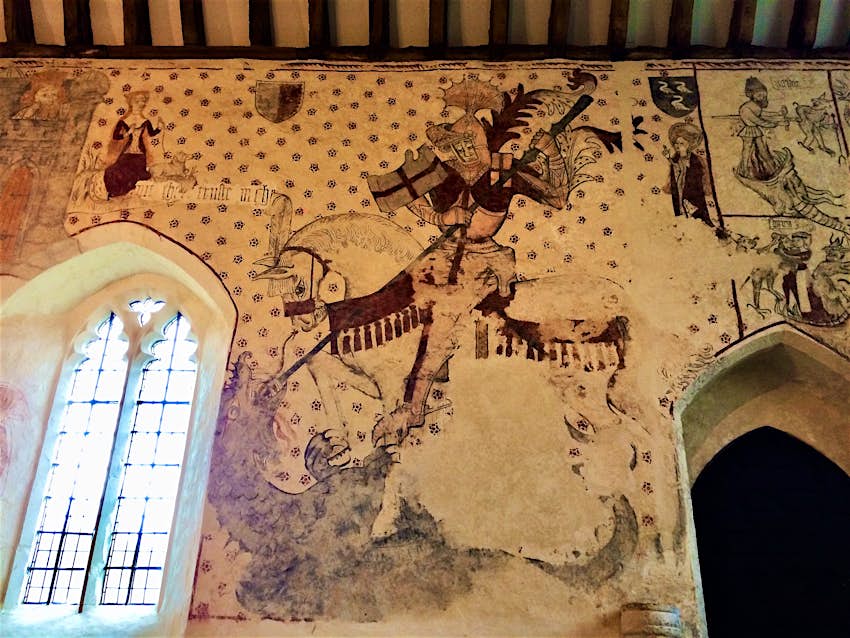A medieval wall painting showing St George killing a dragon