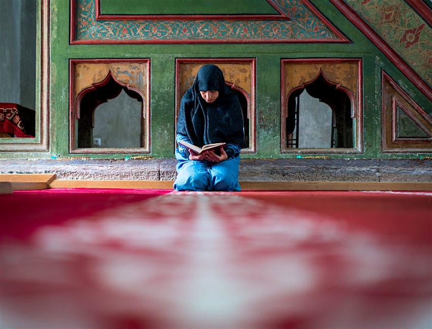 Features - Muslim woman praying A woman prays inside a mosque
