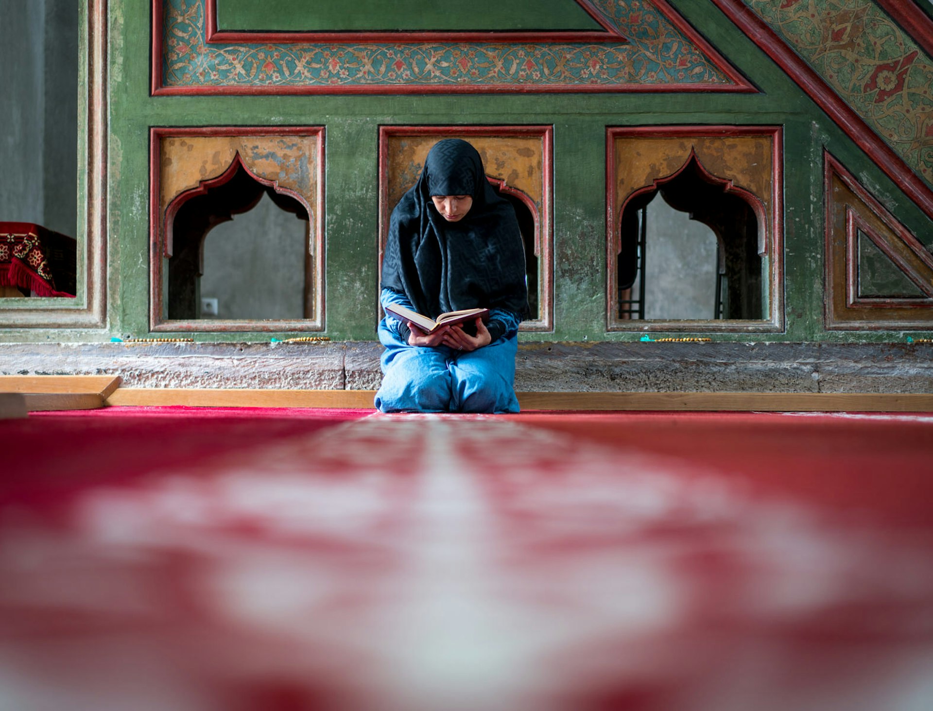 A woman prays inside a mosque