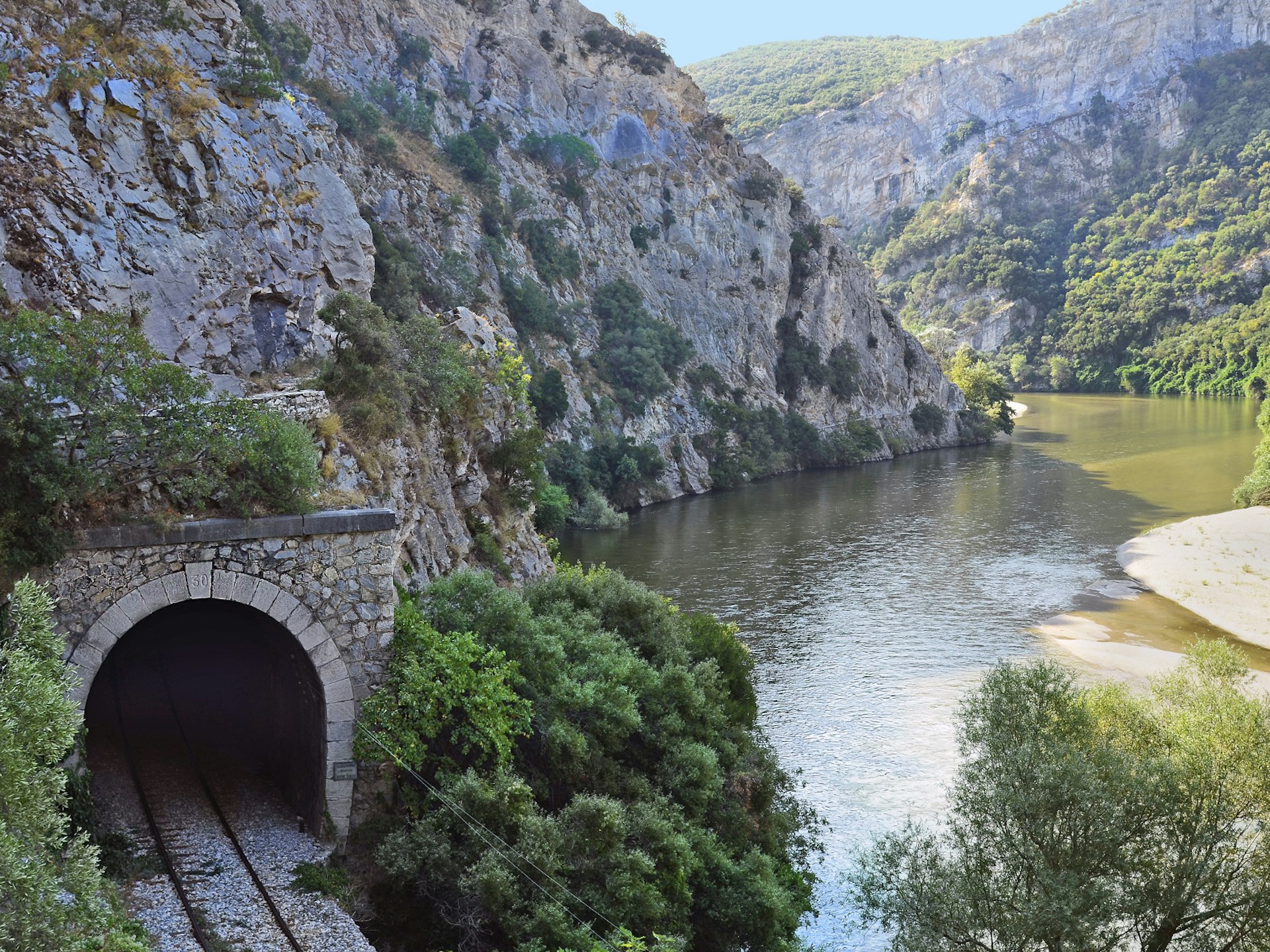 A tunnel and rails of the Drama-Xanthi train line along the Nestos river 