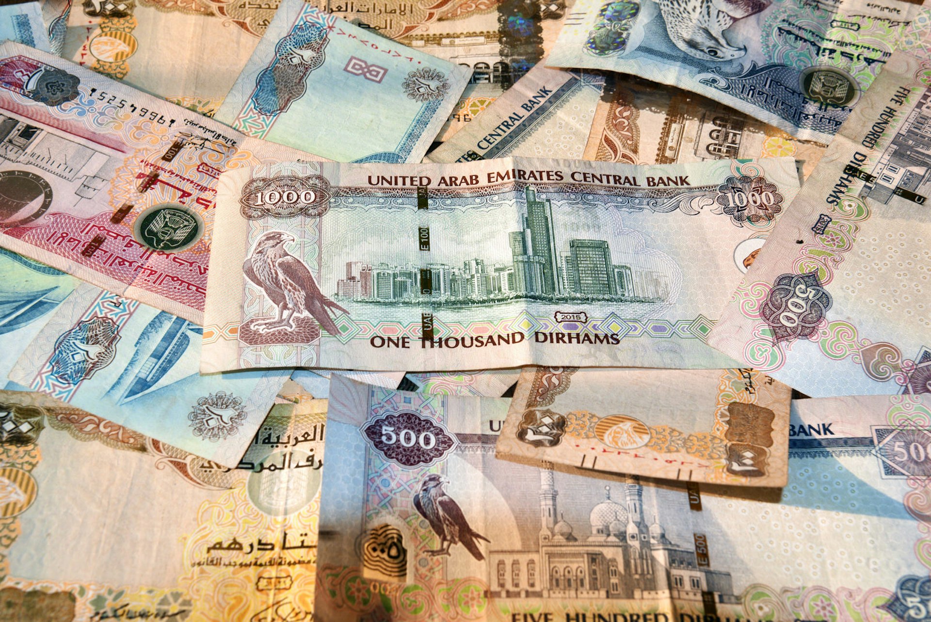 United Arab Emirates currency notes spread on table 