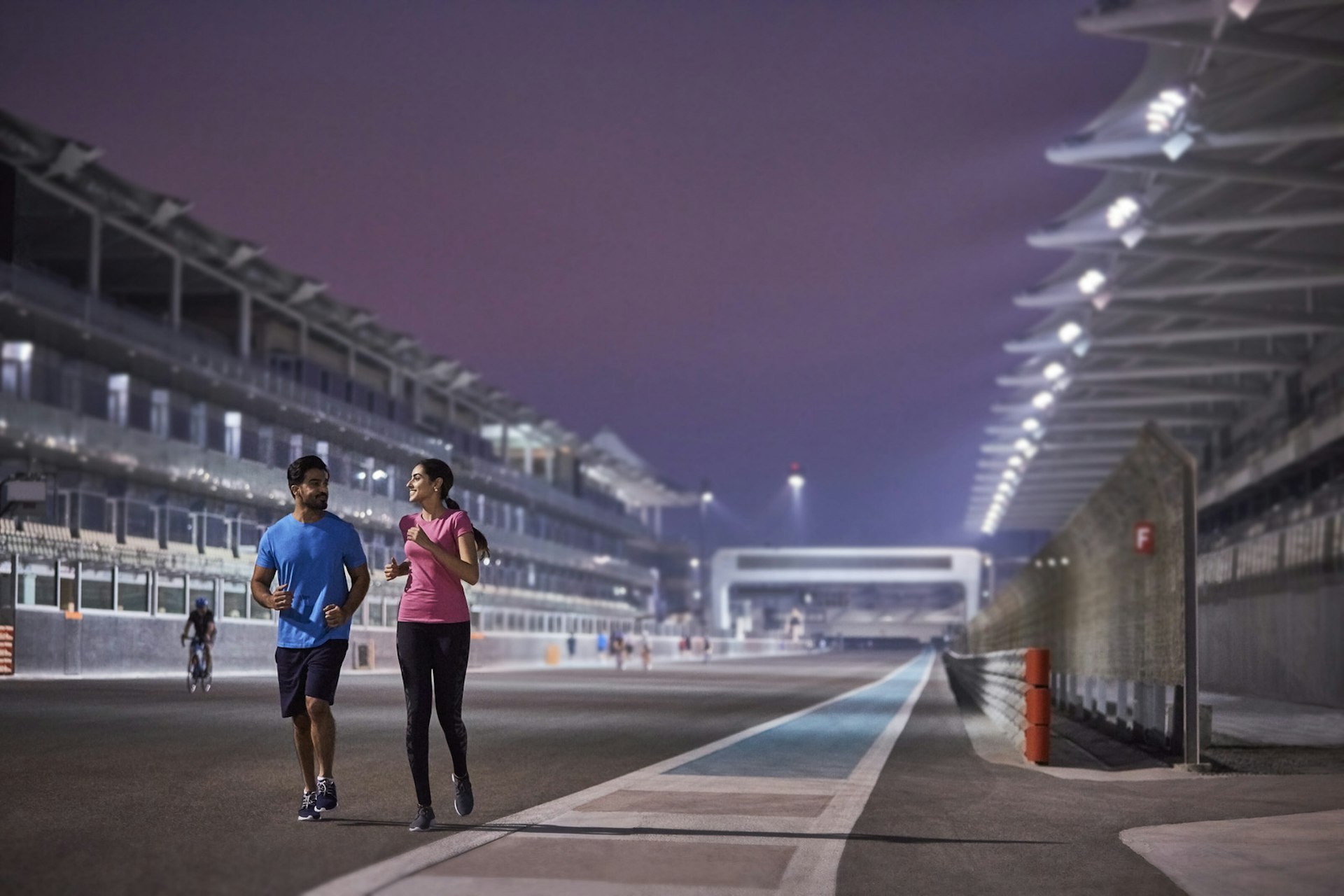 Two joggers on the Yas Marina Formula One racetrack in Abu Dhabi, United Arab Emirates
