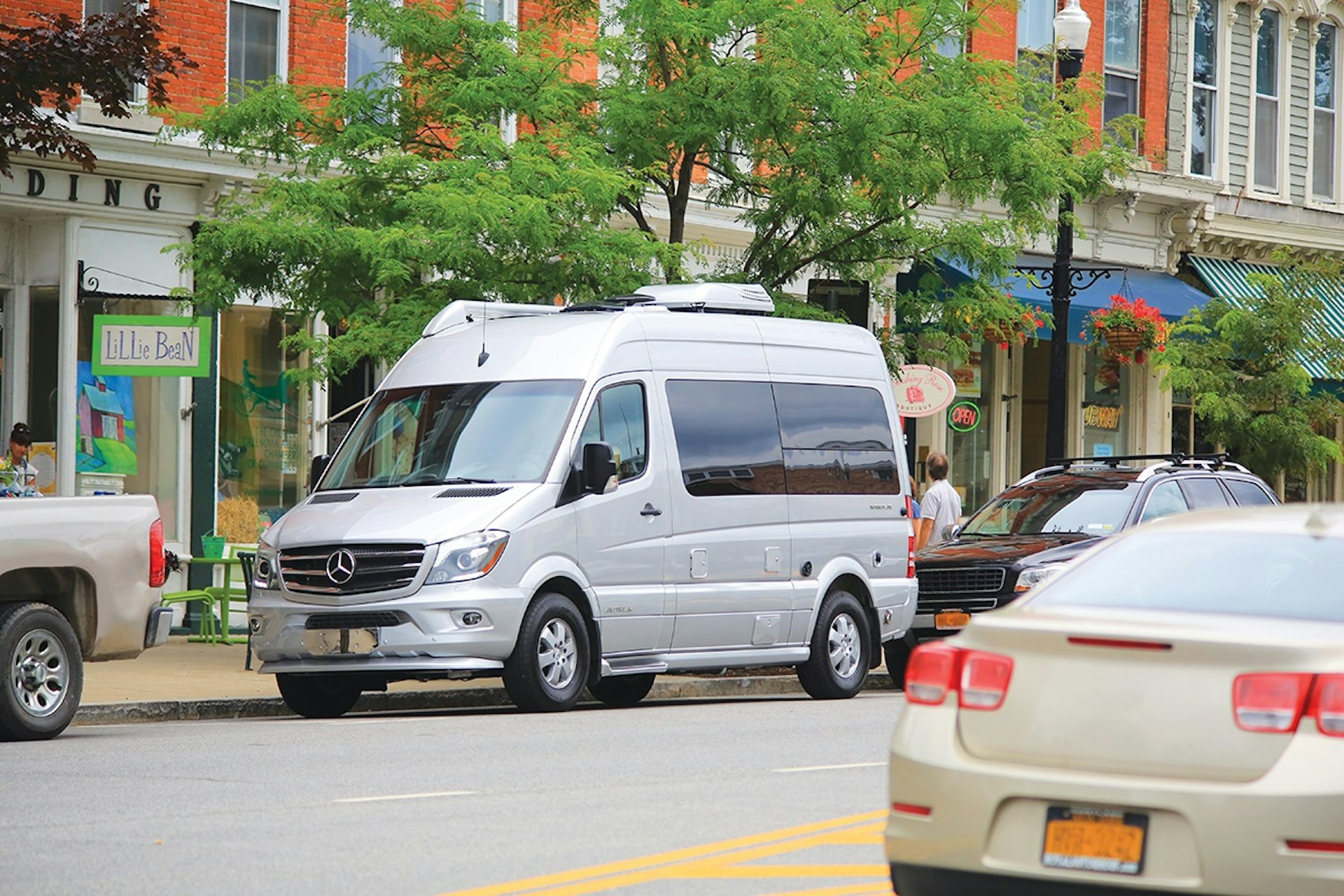 A motorhome is parked on a city street.