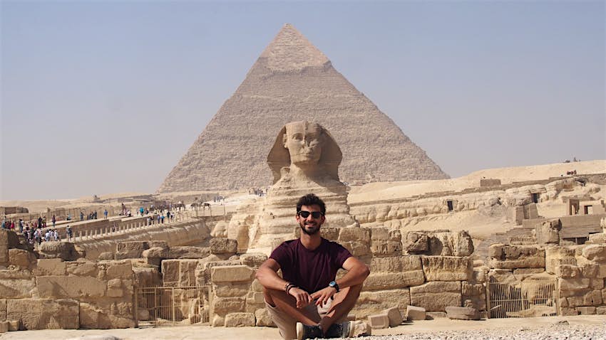 The sphinx and pyramids in Egypt A young man in front of the pyramids in Egypt.