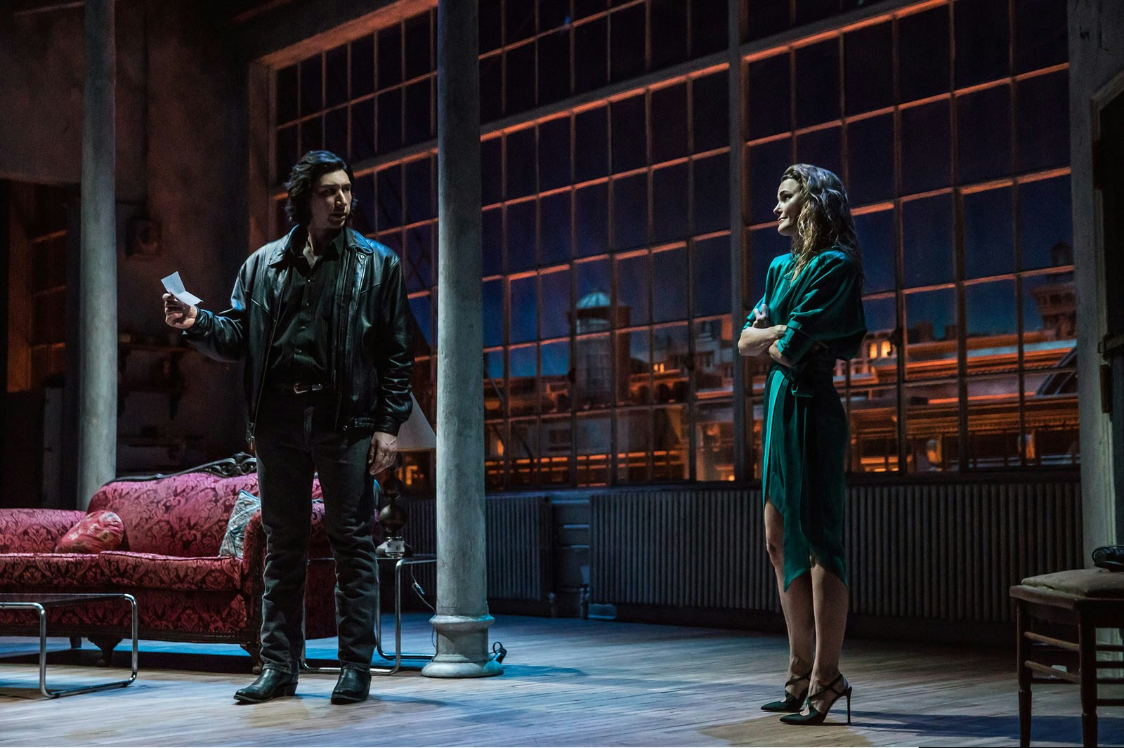 Celebrities West End Broadway - Adam Driver and Keri Russell star in Burn This at the Hudson Theatre, New York. The actors stand on stage, darkly lit, staring at each other in front of a huge multi-paned window © Matthew Murphy