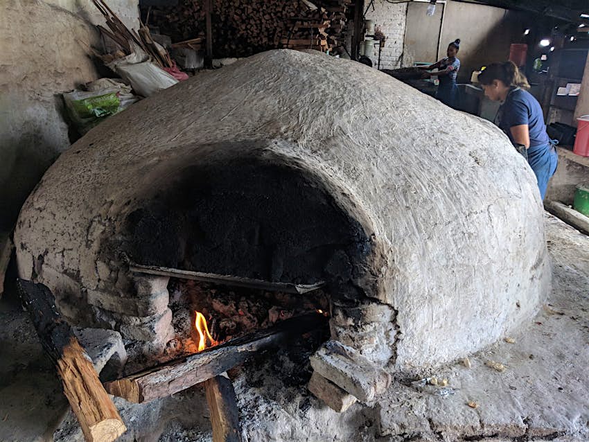 A domed wood-burning clay oven roasts pork at La casa de Doňa Olimpia in Santa Rosa, Honduras 