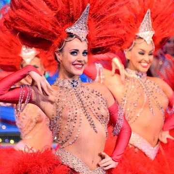 With a sequined top and red head dress Claudine, the Principal Dancer at the Moulin Rouge strikes a pose onstage