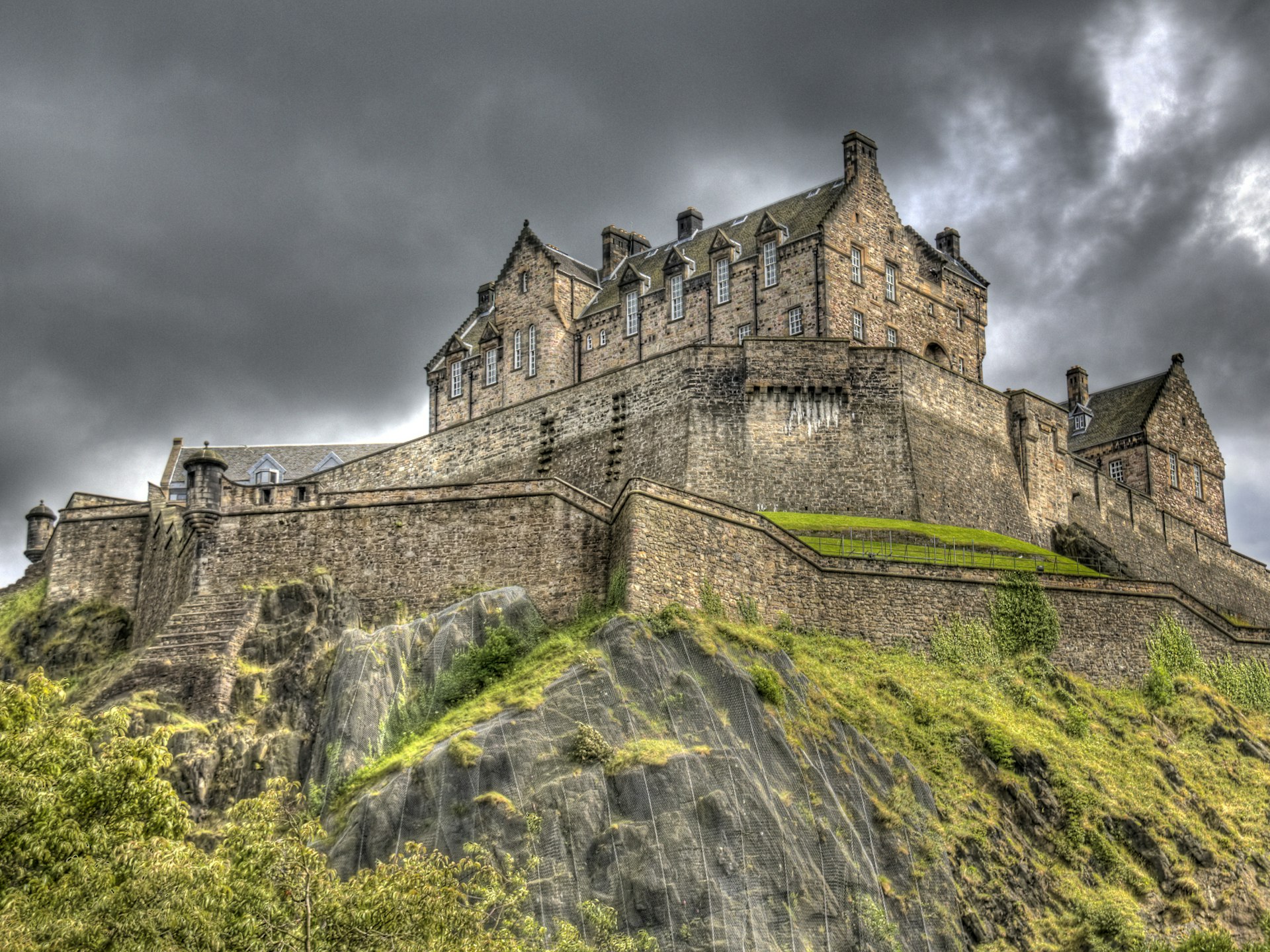 Looking up to Edinburgh Castle with stormy skies in the background