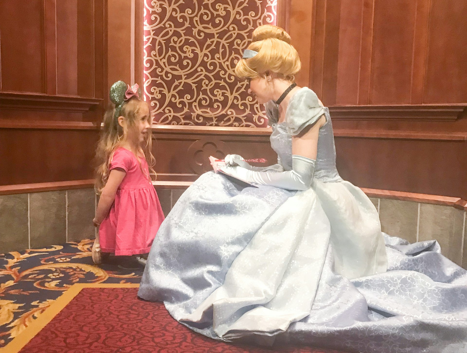 A little girl meets cinderella at Disneyland California
