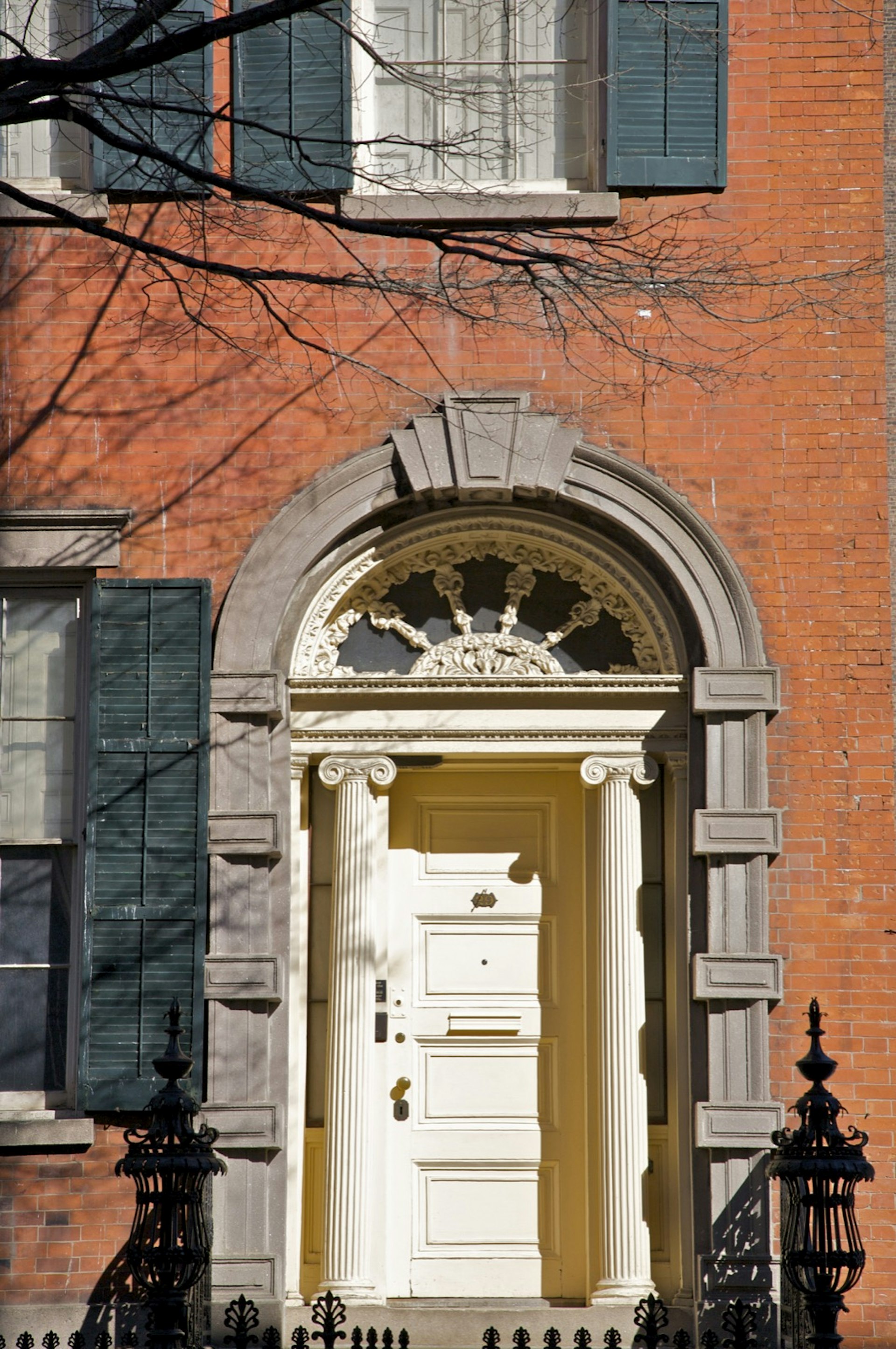 A front door details of The Merchant House Museum, with a white door and columns a top choice New York City Museums