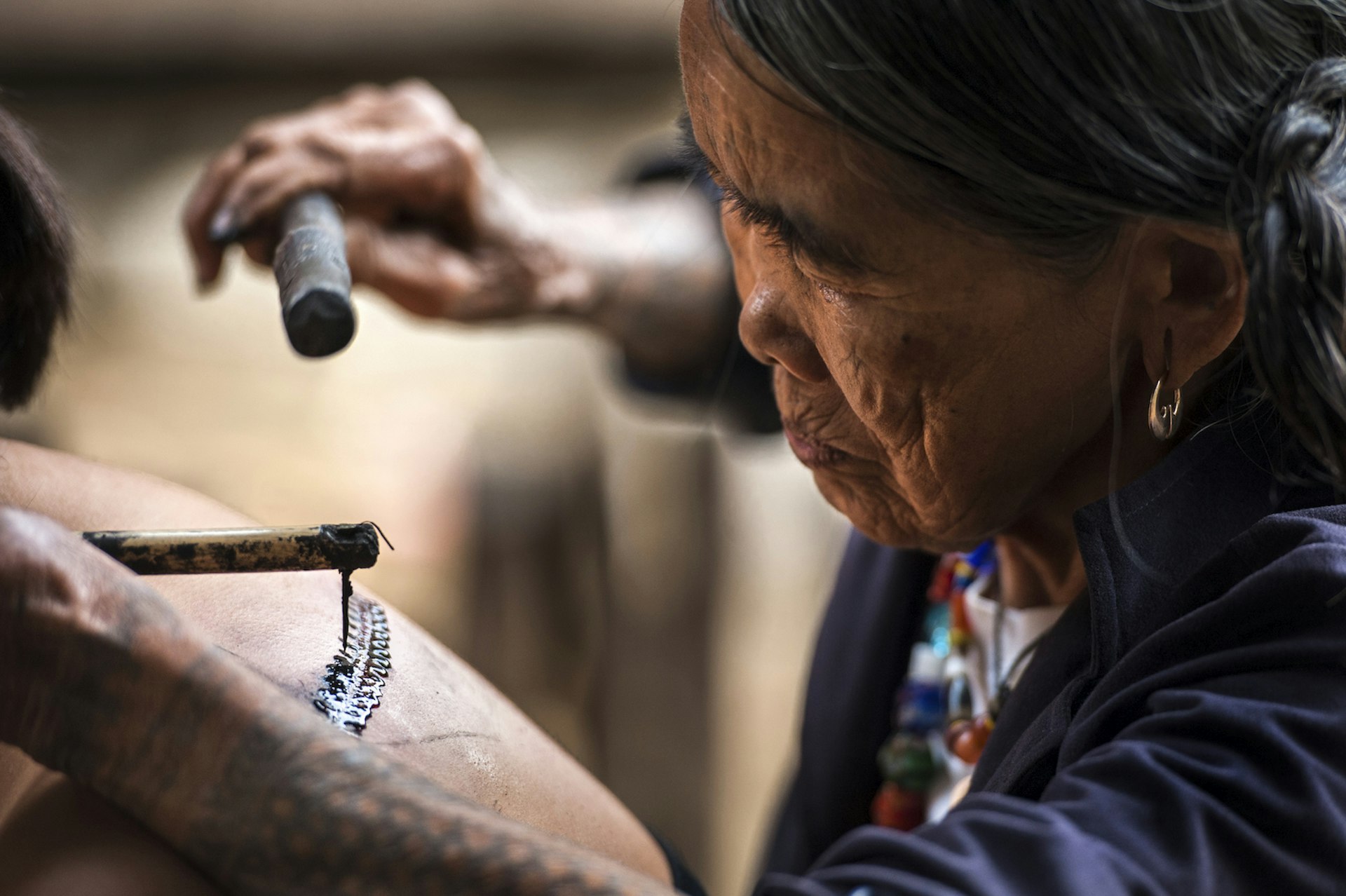 Maria Whang-od – the last traditional Kalinga tattoo master – working on a design