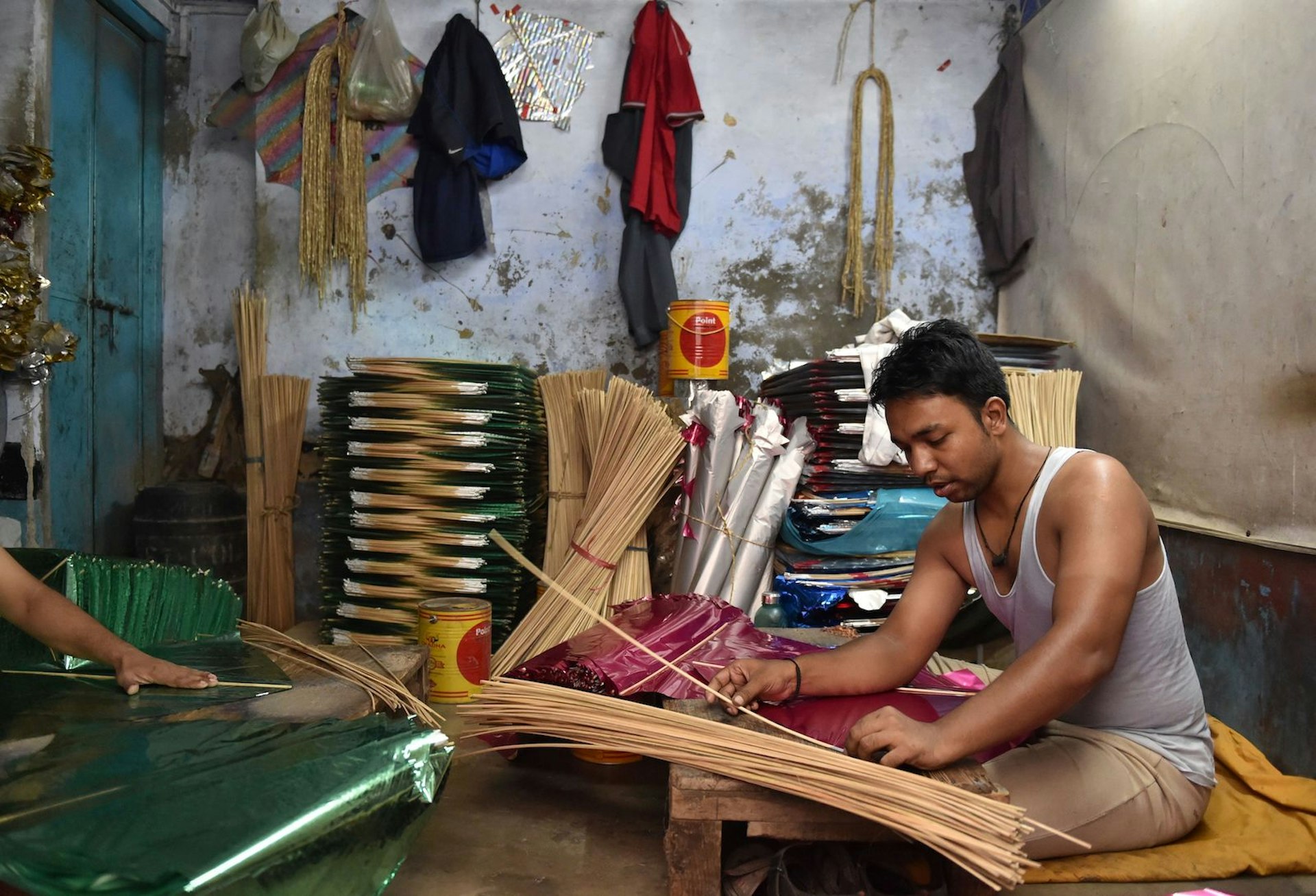 A kite maker prepares their latest creation in a workshop in New Delhi 