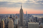 The Empire State Building at sunset is a beautiful site, but it is a New York City landscape you can skip. Instead watch the sunset from another New York City building
