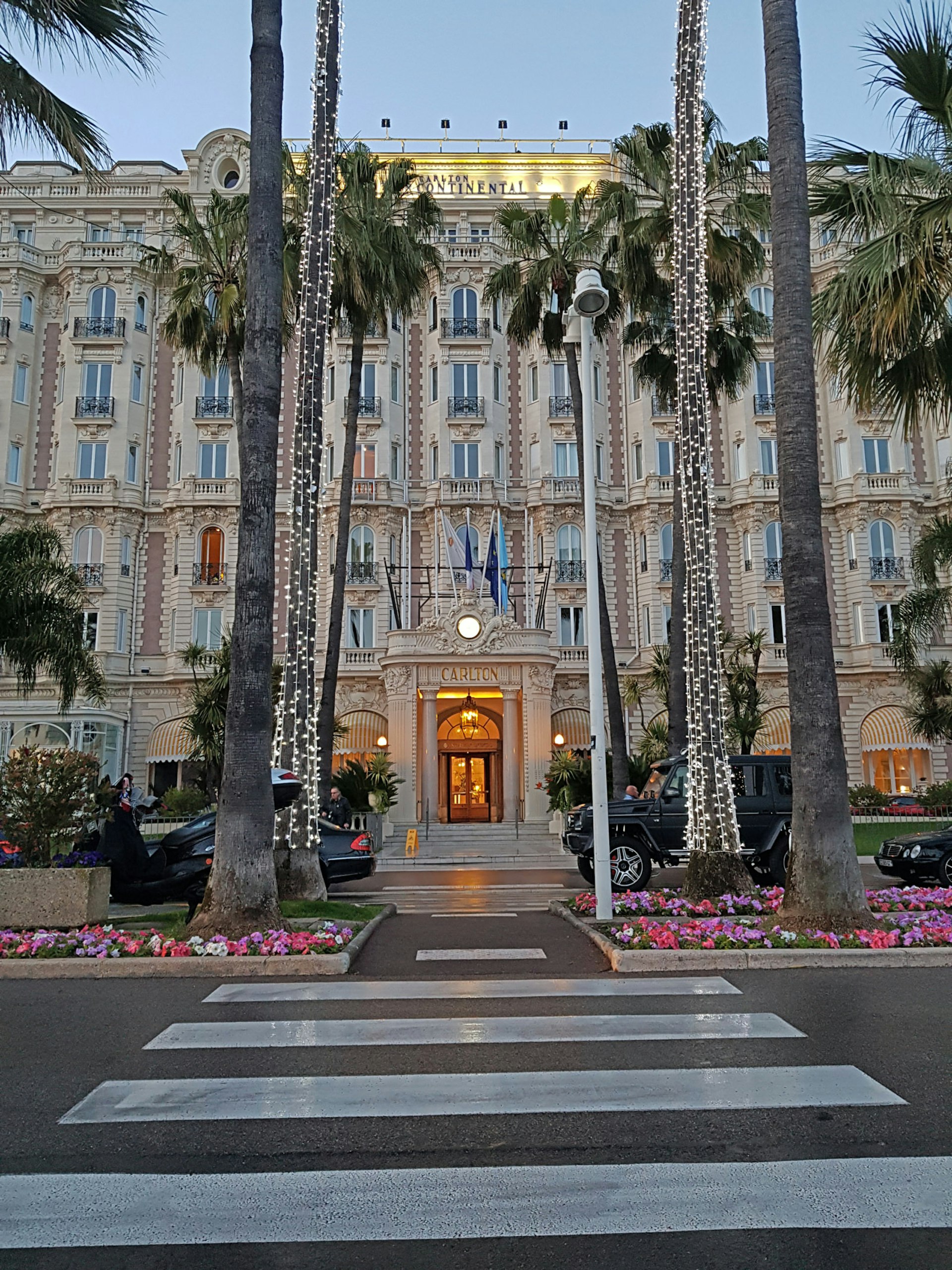 The palm tree lined facade of the InterContinental Carlton Hotel in Cannes, France
