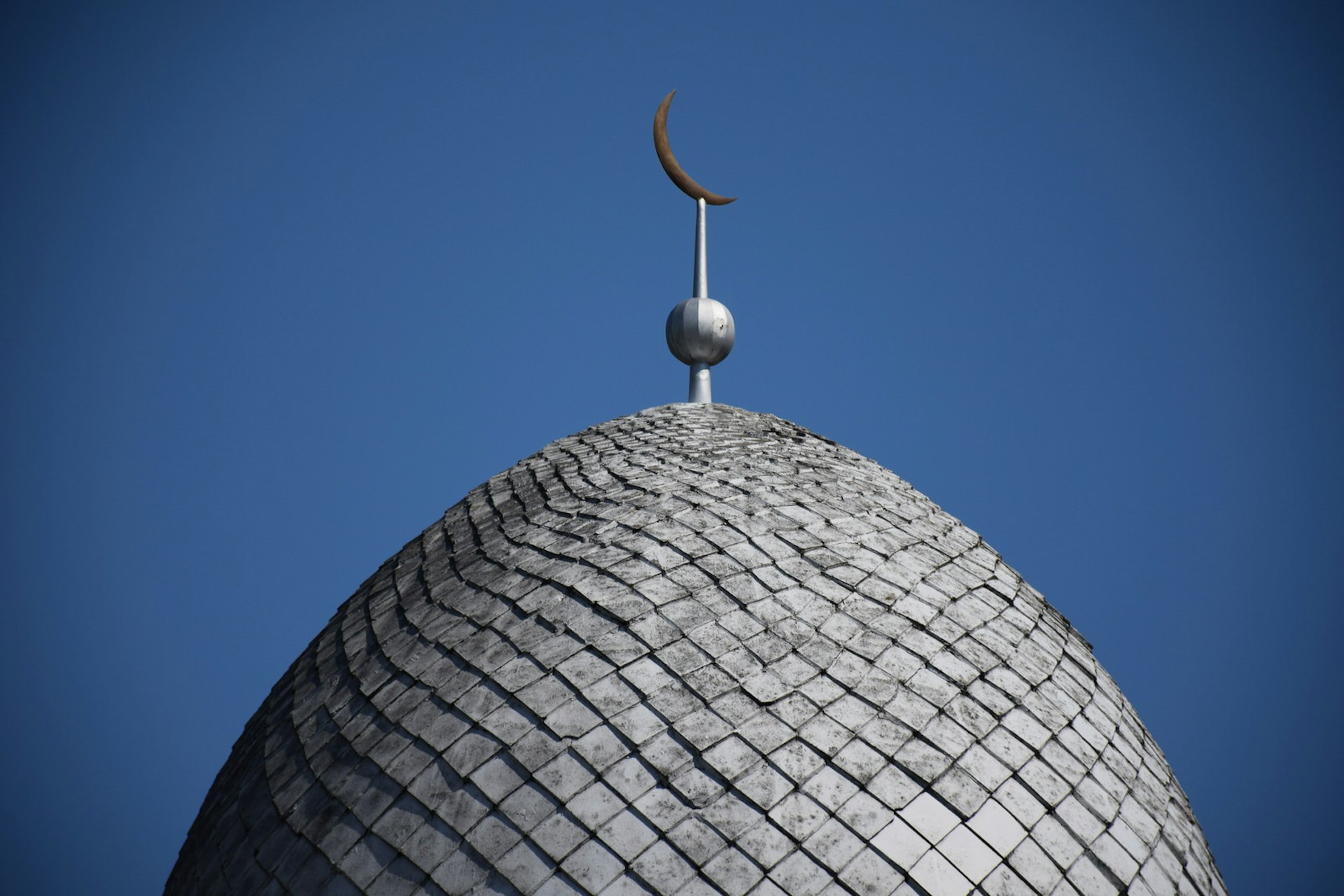 Detail of the tiling on Kaunas Mosque's dome, topped with a crescent
