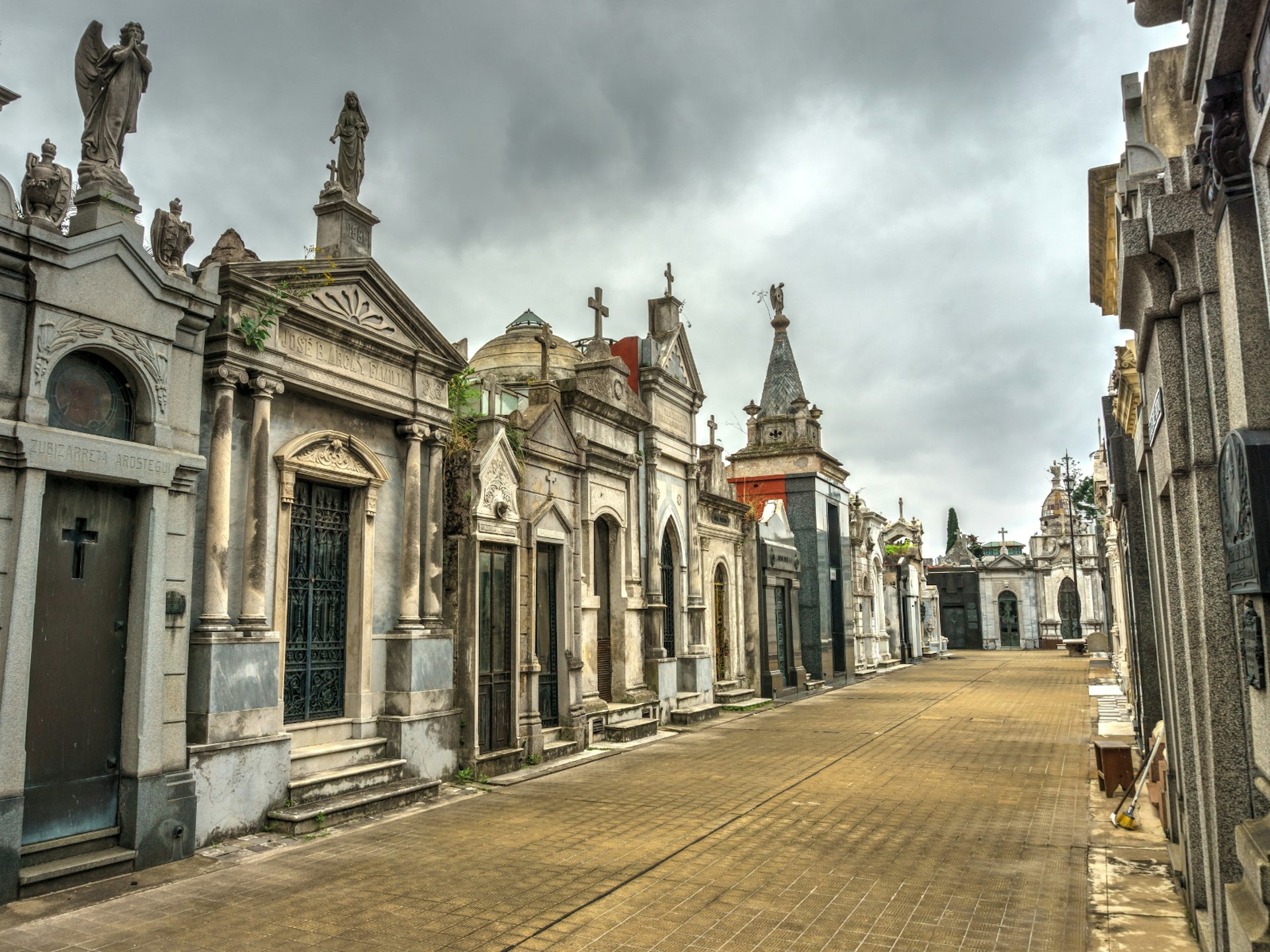 Looking down an avenue of mausoleums and graves at La Recoleta Cemetery
