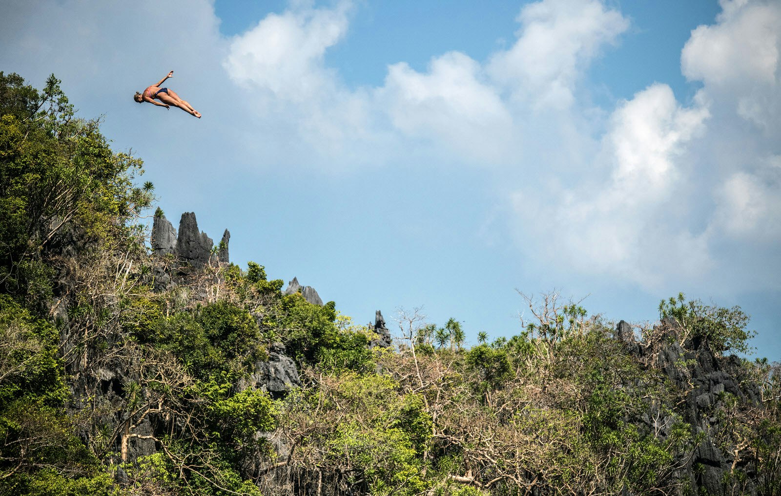 Palawan travel - Philippines: In this handout image provided by Red Bull, Rhiannan Iffland of Australia dives from the 21 metre platform at the Big Lagoon on Miniloc Island during the final competition day of the first stop of the Red Bull Cliff Diving World Series on April 13, 2019 at Palawan, Philippines. (Photo by Romina Amato/Red Bull via Getty Images)