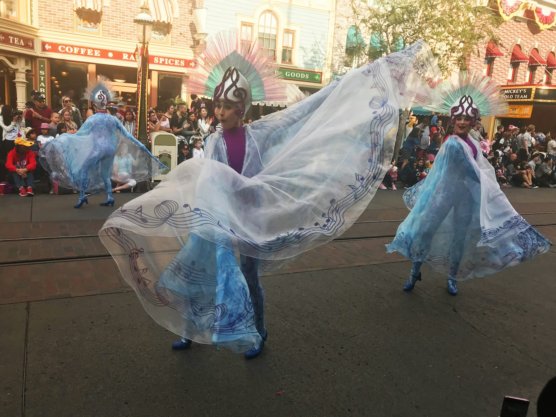 dancers entertain a crowd during a parade at Disneyland, California