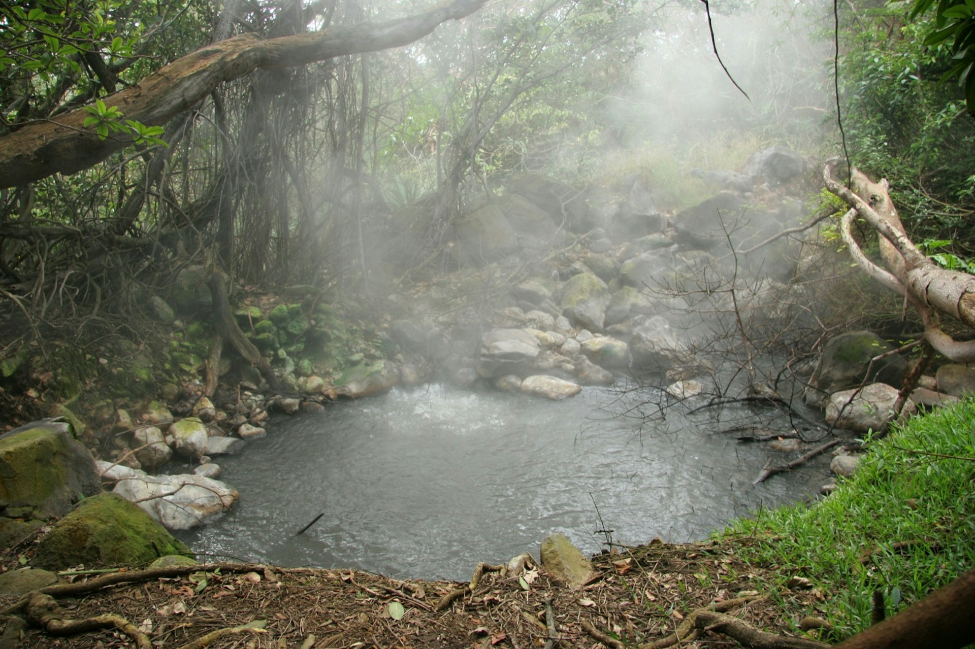 A thick mist rises above a boiling lake at Volcán Rincón de la Vieja park in Costa Rica