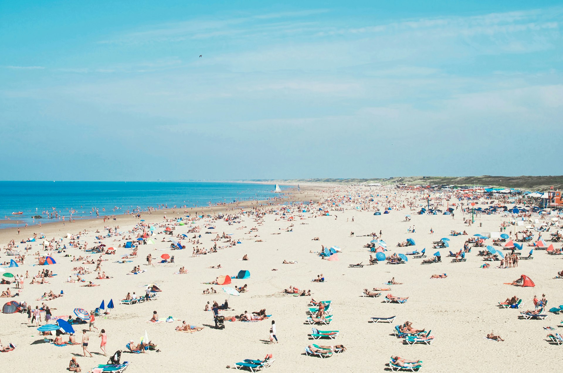 Features - High Angle View Of People At Beach Against Sky