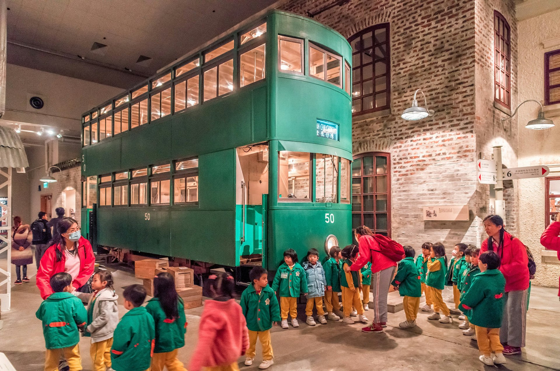Schoolchildren examine an old tram carriage in the Hong Kong Museum of History
