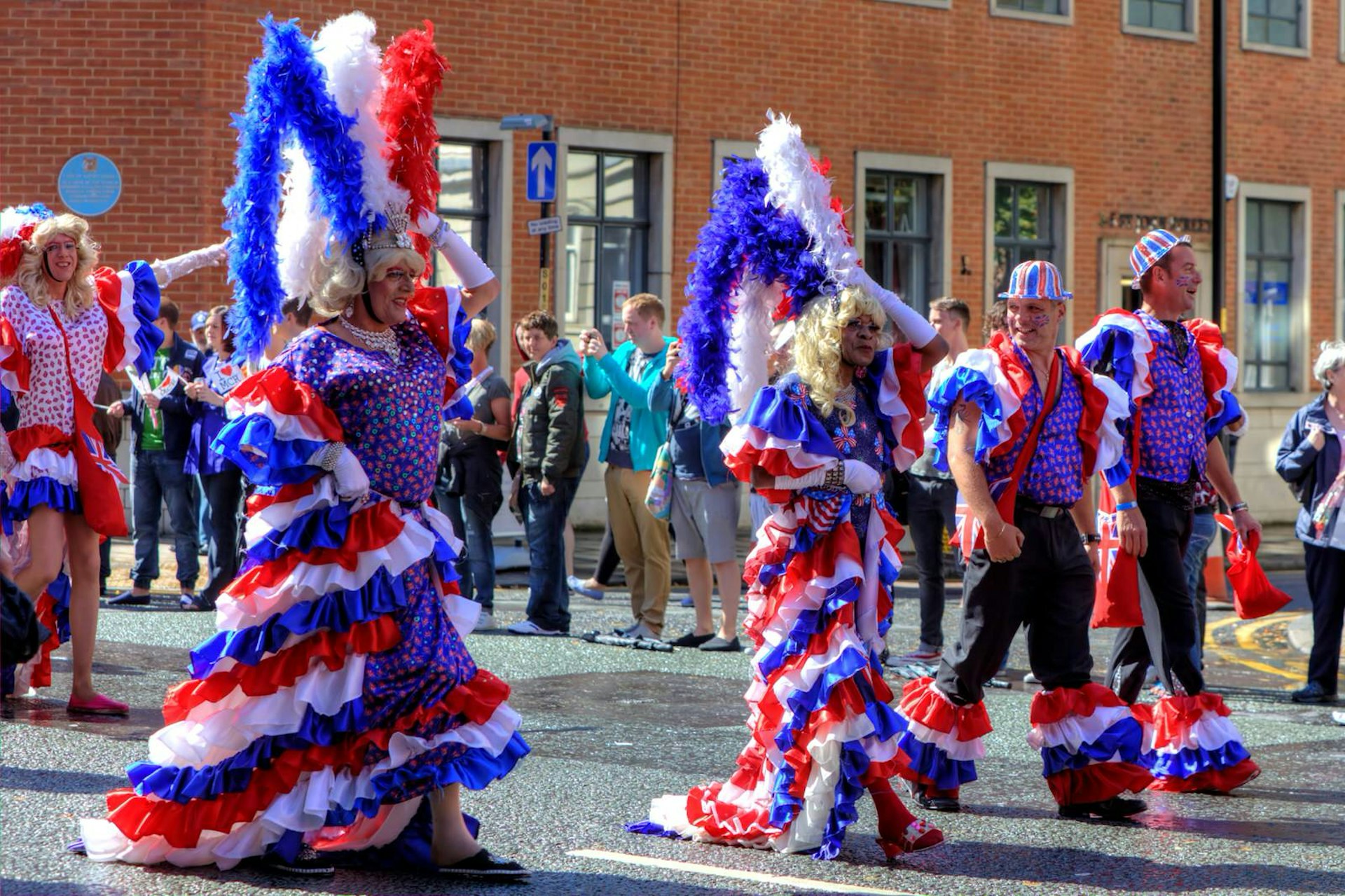 Parade participants in red, white and blue costumes at Manchester Pride in the UK