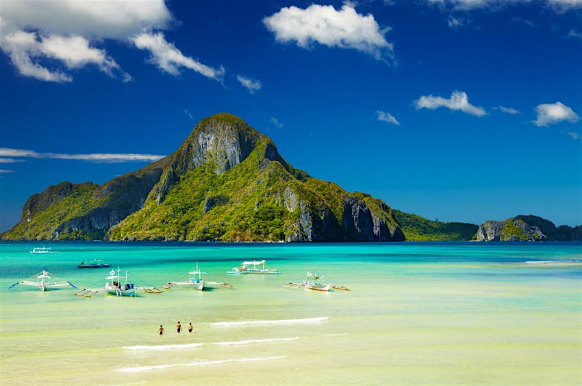 Features - El Nido bay, Palawan island, Philippines. Palawan travel - View of green mountain and tropical beach, El Nido bay, Palawan island, Philippines