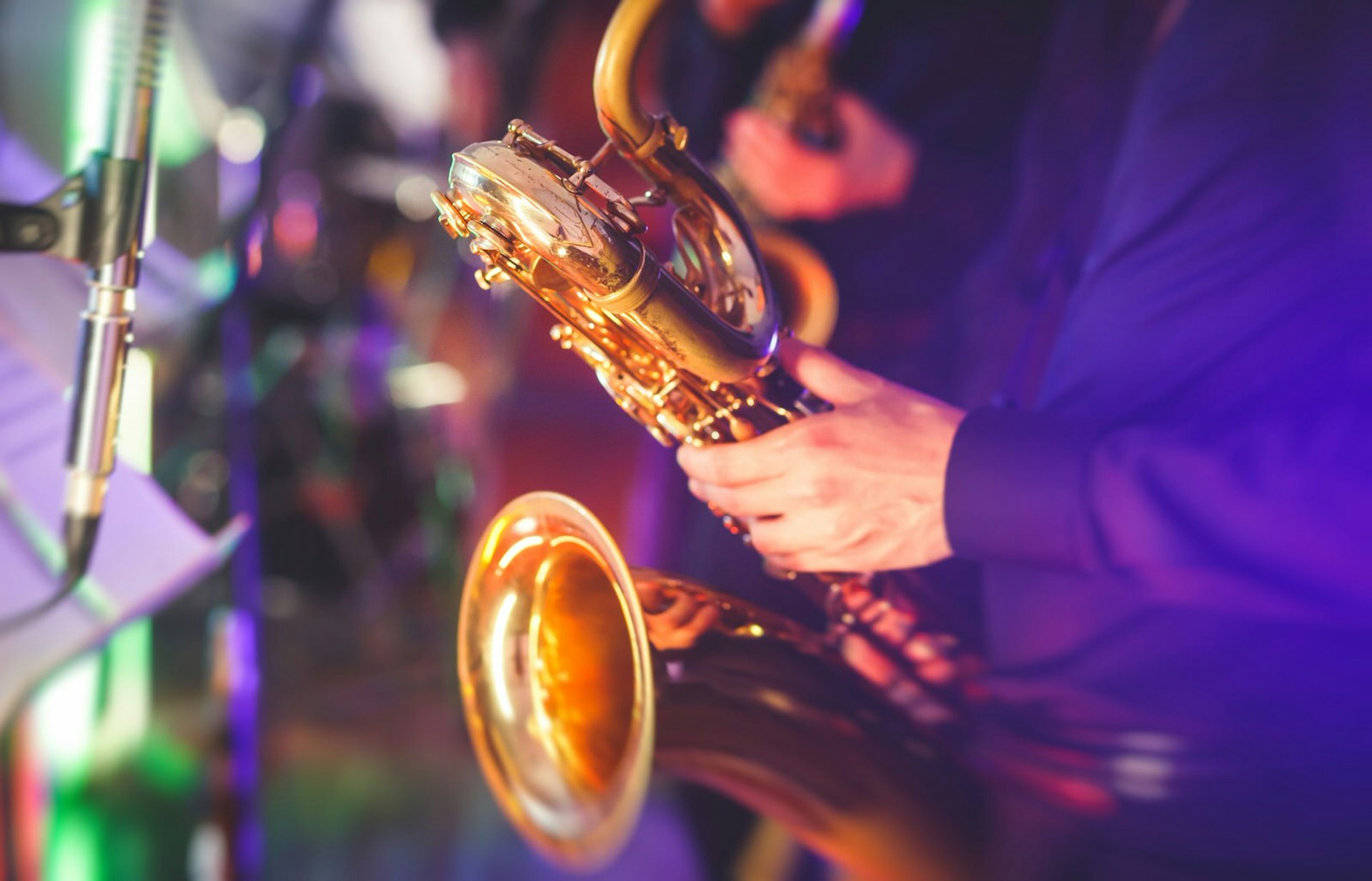 A close up shot of a jazz musician playing a saxophone 
