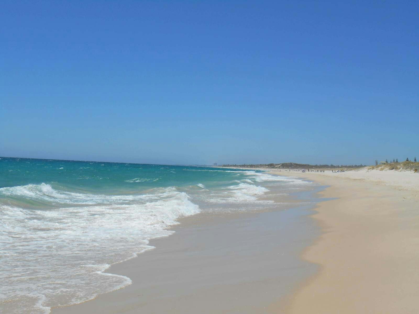 Endless sand and blue sky at Swanbourne Beach, one of Australia's best nude beaches