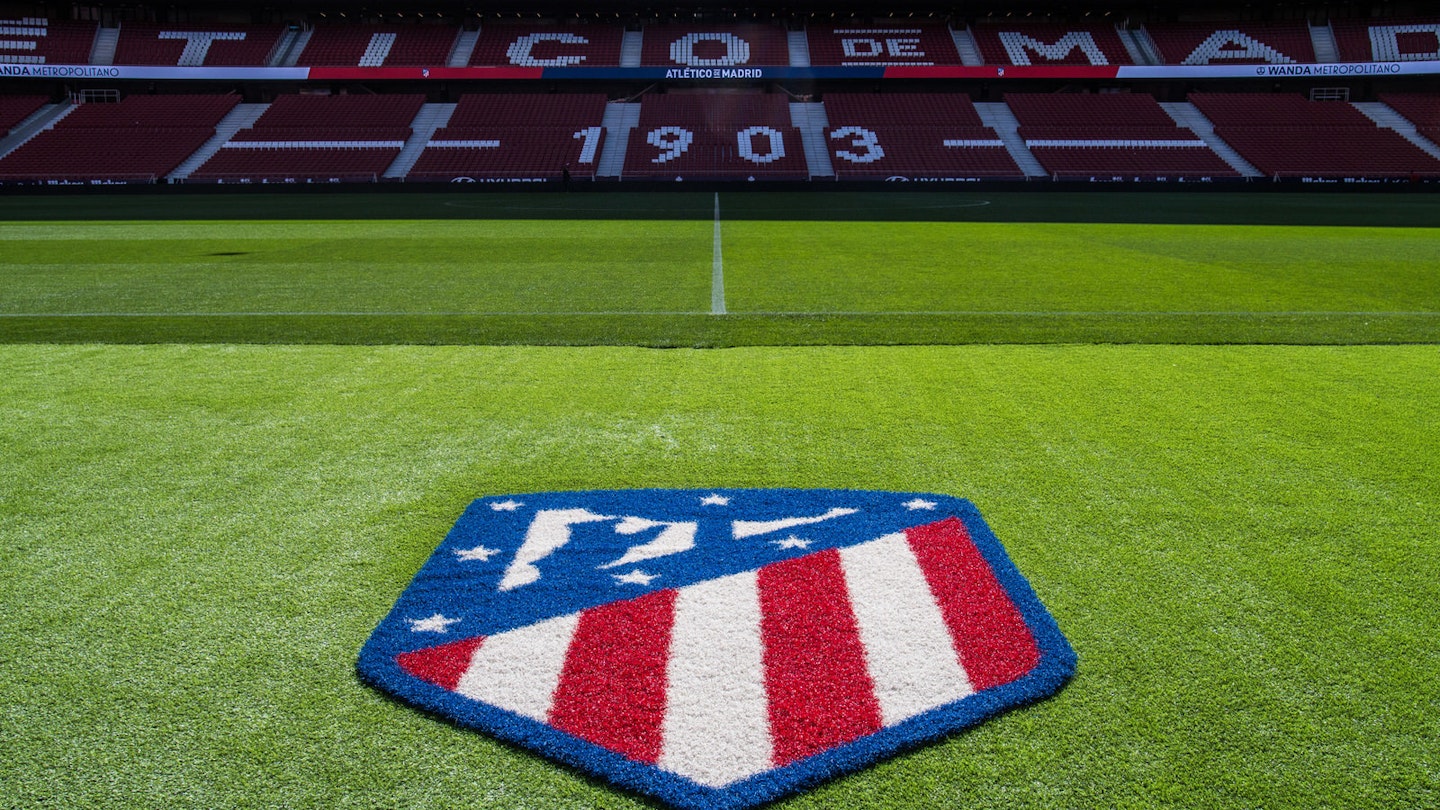 The Atlético Madrid badge on the pitch in the Wanda Metropolitano stadium