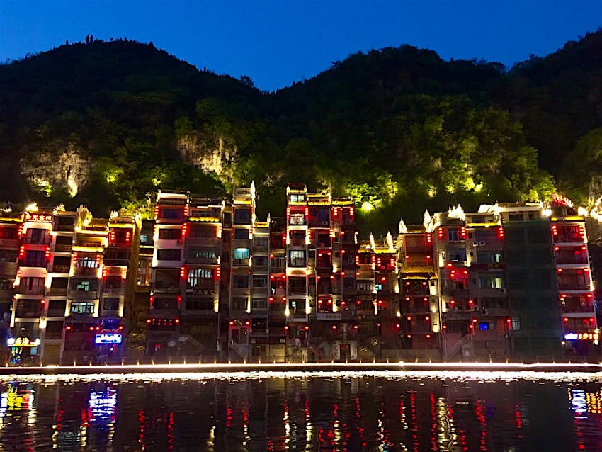 Features - Evening lights reflected in the Wuyang River in Zhenyuan © Megan Eaves / Lonely Planet Evening lights reflected in the Wuyang River in Zhenyuan © Megan Eaves / Lonely Planet