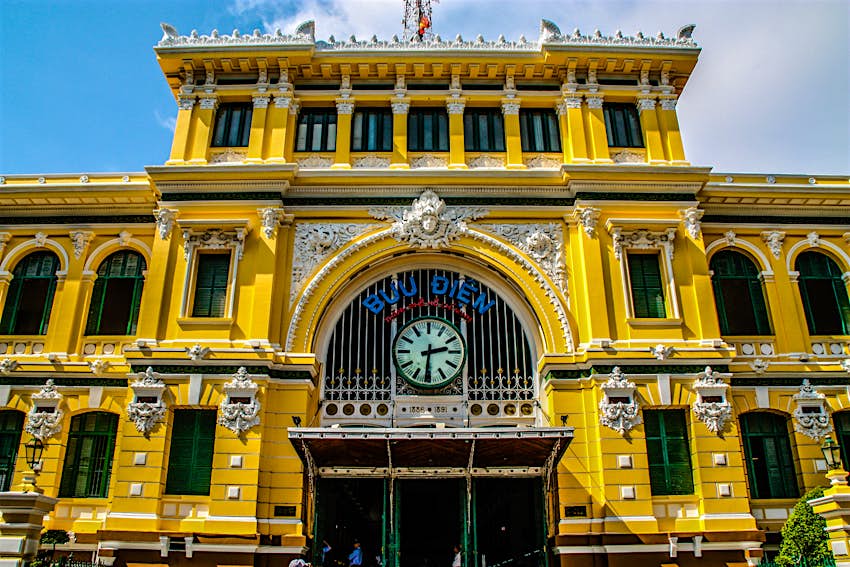 The bright yellow exterior of the French colonial era Saigon Central Post office, HCMC