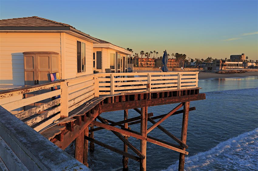 Two white cottages are built on a pier over the Pacific Ocean stay here on a perfect weekend in San Diego