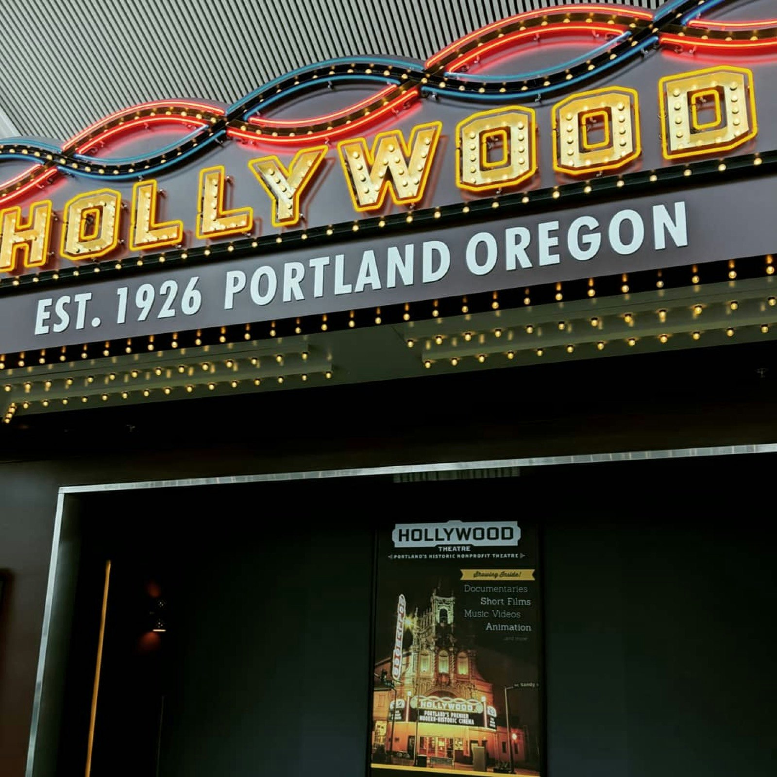 The front of a movie theater inside the Portland International Airport, or PDX, is shown. It's got a yellow marquee that spells Hollywood